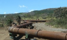 Piping for geothermal energy snake through dry forest around Rincon de la Vieja Volcano